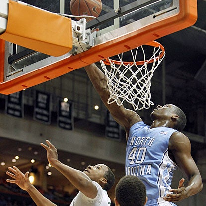 Harrison Barnes elevates way over two Miami players to tap in a basket. Barnes finishes with 23 points. (AP)