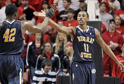 Donte Poole (right), who finishes with a game-high 25 points, gets kudos from Ivan Aska after burying one from downtown.  (AP)