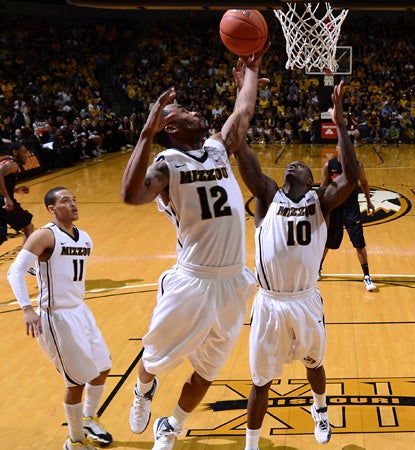 Missouri's Marcus Denmon (No. 12) leads the Tigers in a revenge game with 17 points against Oklahoma State. (AP)