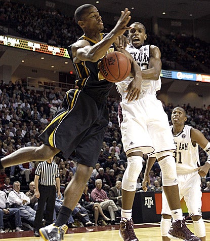 Missouri's Kim English (left) battles with Texas A&M's Khris Middleton. English scores 21 points in the Tigers' 71-62 win. (AP)