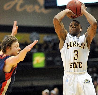 Isaiah Canaan, who scores 17 of his 23 points in the first half, shoots over Matthew Delavedova. (AP)