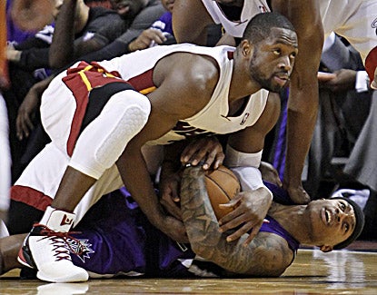 Dwyane Wade (top) battles with Isaiah Thomas for the ball. Wade scores 30 points in the  Heat's 120-108 win. (AP)