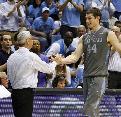 Coach Roy Williams congratulates Tyler Zeller, who scores 30 points in his final home game. (AP)