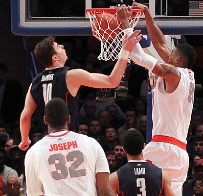 Fab Melo slams home two points as Syracuse's 11th straight victory puts the Orange in the Big East semifinals.  (US Presswire)