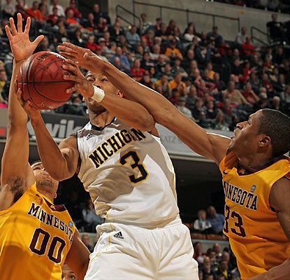 Trey Burke drives to the basket, finishing with a career-high 30 points, including seven in overtime. (Getty Images)