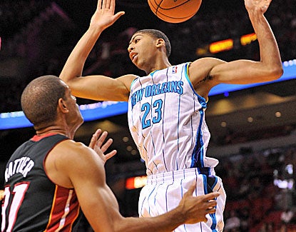 Hornets rookie power forward Anthony Davis dunks on Heat small forward Shane Battier. (US Presswire)