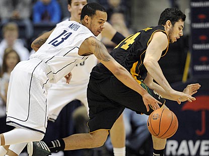 Connecticut junior Shabazz Napier steals the ball from Vermont's Josh Elbaum during the first half.  (AP)