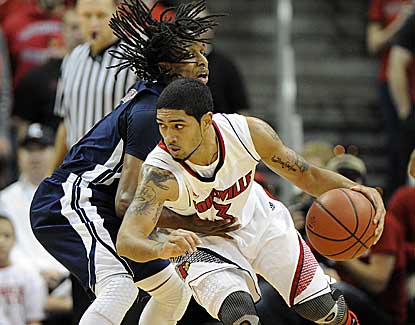 Louisville's Peyton Siva drops his shoulder against Russell Wilson in the Cards' win over Samford. (US Presswire)