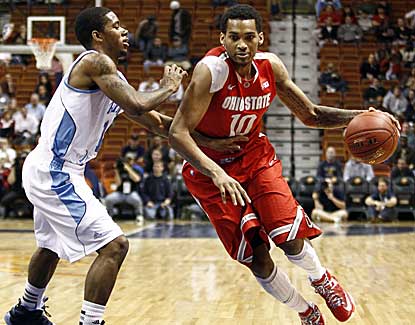 Ohio State forward LaQuinton Ross drives past Rhode Island's Mike Powell on Saturday. (US Presswire)