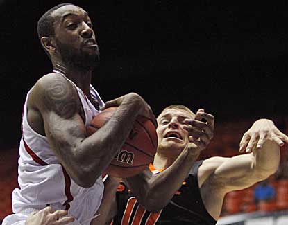 NC State's C.J. Leslie battles for a rebound with Phil Forte of Oklahoma State on Sunday. (AP)