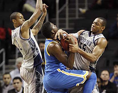 Georgetown's Jabril Trawick ties up UCLA's Jordan Adams in the Hoyas' 78-70 win. (AP)