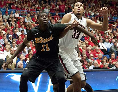 Arizona forward Grant Jerrett battles with Long Beach State's James Ennis during the first half. (US Presswire)