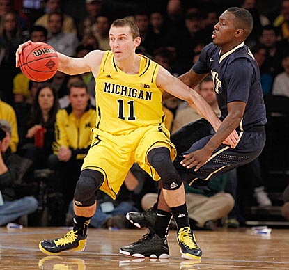 Michigan freshman Nik Stauskas, guarded here by Pittsburgh's Tray Woodall, scores 15 points off the bench.  (Getty Images)