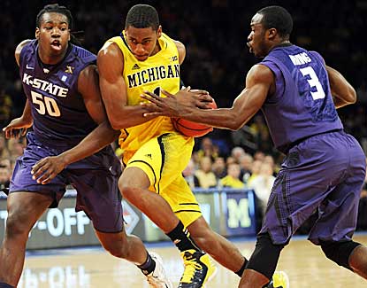 Michigan's Glenn Robinson III drives to the hoop against KSU's D.J. Johnson, left, and Martavious Irving. (AP)
