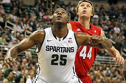 Michigan State's Derrick Nix holds out Louisiana-Lafayette's Matthew Moss while looking for a rebound Sunday afternoon.   (US Presswire)