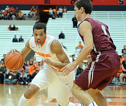 Syracuse guard Michael Carter-Williams looks for driving room as Colgate's Luke Roh defends Sunday at the Carrier Dome.  (US Presswire)