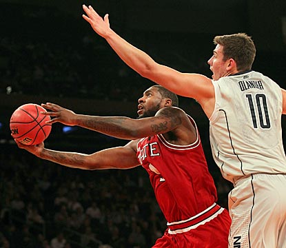 Richard Howell drives past Connecticut's Tyler Olander during a productive second half for the Wolfpack senior.  (US Presswire)