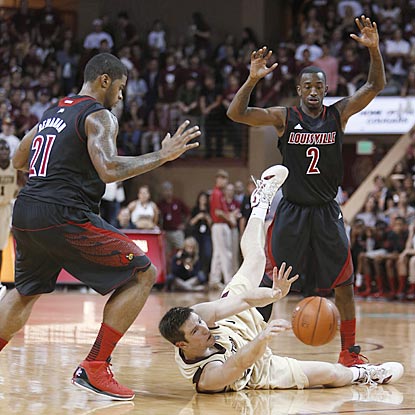 College of Charleston's Willis Hall has a little trouble trying to break Louisville's full-court press during the first half.  (AP)
