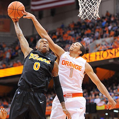 Syracuse's Michael Carter-Williams blocks Kris Gulley's shot and helps limit Long Beach State to 29.2 percent shooting.  (US Presswire)
