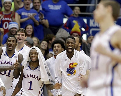 The Jayhawks cheer on reserve Tyler Self (right), who scores on the final play in the blowout over Colorado. (AP)