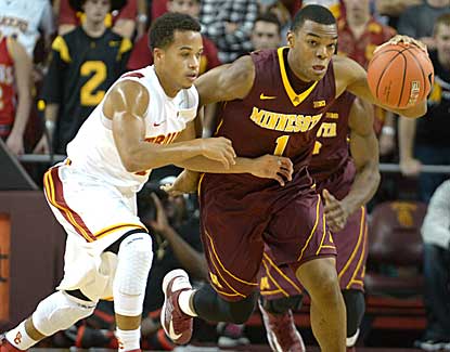 Minnesota guard Andre Hollins works the ball against USC's Chass Bryan on Saturday night. (US Presswire)