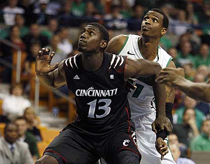 Cincinnati's Cheikh Mbodj boxes out Marshall's Nigel Spikes. Mbodj has four boards and nine points.  (US Presswire)