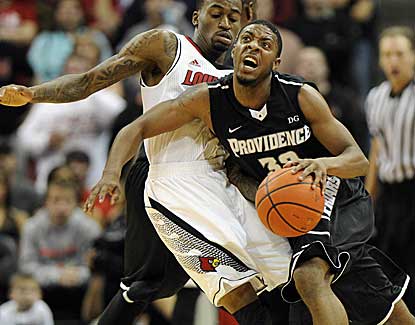 Providence guard Vincent Council tries to drive past Russ Smith, who scores a game-high 23 points. (US Presswire)