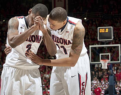 Mark Lyons (left) and Brandon Ashley see their prayer answered: Colorado's winning shot is nixed and Arizona capitalizes. (US Presswire)