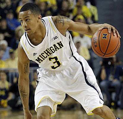 Trey Burke leads an offensive explosion for Michigan, putting up 19 points and a career-high 12 assists.  (AP)