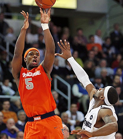 Syracuse's C.J. Fair, who scores 23  points and grabs 11 boards, shoots over Providence's LaDontae Henton. (AP)