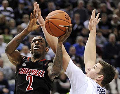 Louisville's Russ Smith, who scores a game-high 23 points, shoots around UConn's Tyler Olander. (AP)