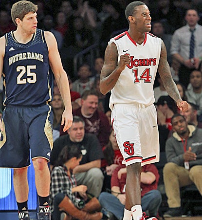 JaKarr Sampson (right), who scores 14 of his 17 points in the first half, is pleased after a call goes for St. John's. (AP)