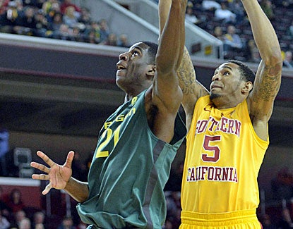 Oregon Ducks guard Damyean Dotson scores 2 of his 16 points against USC on Thursday night. (US Presswire)