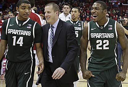 The Spartans celebrate after grinding it out to win their second straight at the Kohl Center. (AP)