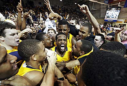 Ramon Galloway (center) is the hero as fans storm the court after La Salle's first win over a top-10 team since 1980. (AP)