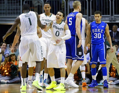 Miami's Shane Larkin (right) celebrates after Durand Scott (left) scores against Duke during a dominating first half. (AP)