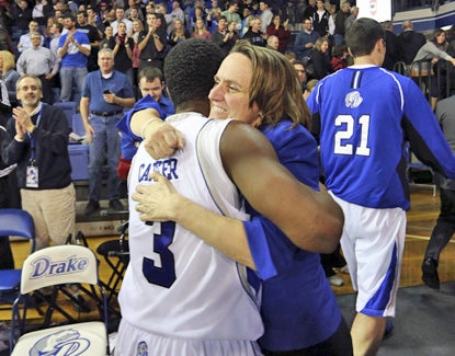 Drake guard Richard Carter, who scores a team-high 20 points, embraces by athletic director Sandy Hatfield Clubb after the win. (AP)
