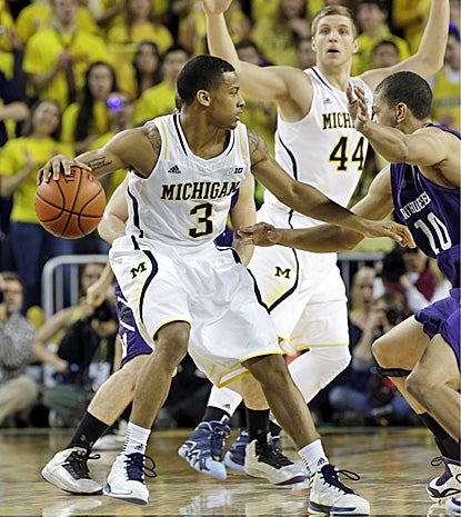 Trey Burke, who scores 18 points and dishes out eight assists, looks to pass against Northwestern. (AP)