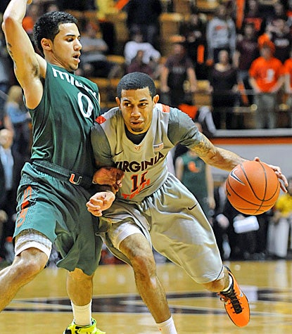 Shane Larkin (left), who scores a team-high 25 points for Miami, defends Virginia Tech's Erick Green in the Hurricanes' win. (AP)