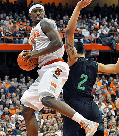 C.J. Fair, who scores 18 points, pulls down one of his 10 rebounds in Syracuse's win over Notre Dame in the Carrier Dome.  (AP)
