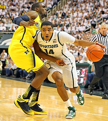 Gary Harris (right), who scores 17 points to lead the Spartans, drives past Michigan's Glenn Robinson III. (US Presswire)