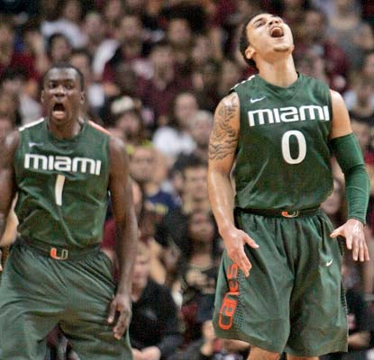 Durand Scott (left), Shane Larkin and the Canes are the first to start 11-0 in the ACC in 12 years.  (AP)