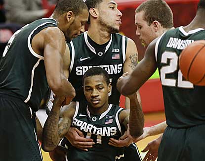 Teammates help up Michigan State's Keith Appling, who scores 16 to surpass the 1,000 point mark for his career. (AP)
