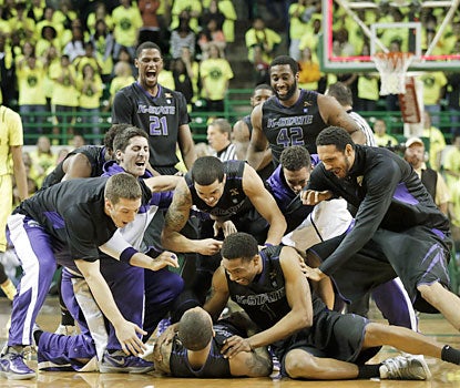 Rodney McGruder is mauled by teammates after he sinks the winning 3 at the buzzer. (AP)