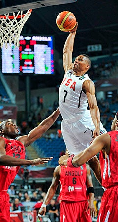 Russell Westbrook goes high over the Angola defenders to slam home two for Team USA. (AP)