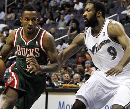 Gilbert Arenas (right) plays only three minutes against the Bucks before leaving with a strained groin.  (AP)
