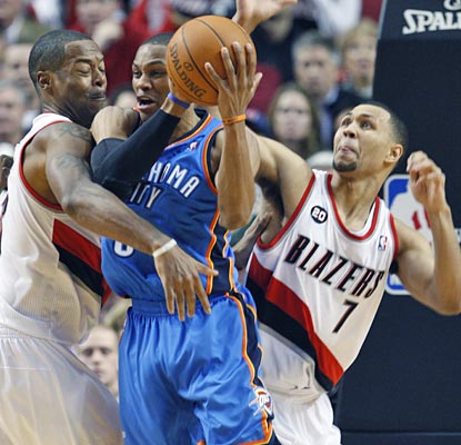 Russell Westbrook pulls in one of his 11 rebounds, to help match Kevin Durant's 28 points and 11 rebounds.  (AP)