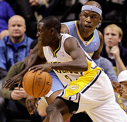 Pacers guard Darren Collison drives past a stunned Al Harrington on his way to 29 points. (Getty Images)