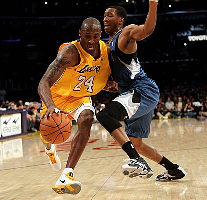 Kobe Bryant slips past Wolves defender Wes Johnson on his way to 33 points. (Getty Images)