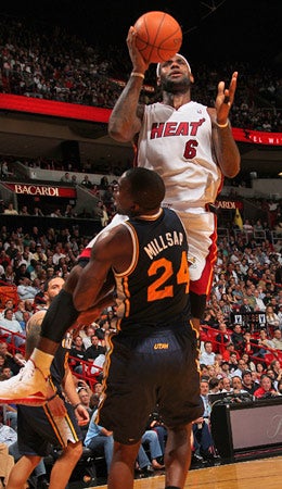 LeBron James rises above Paul Millsap on this play, but it was Millsap who lifted the Jazz to victory Tuesday. (Getty Images)